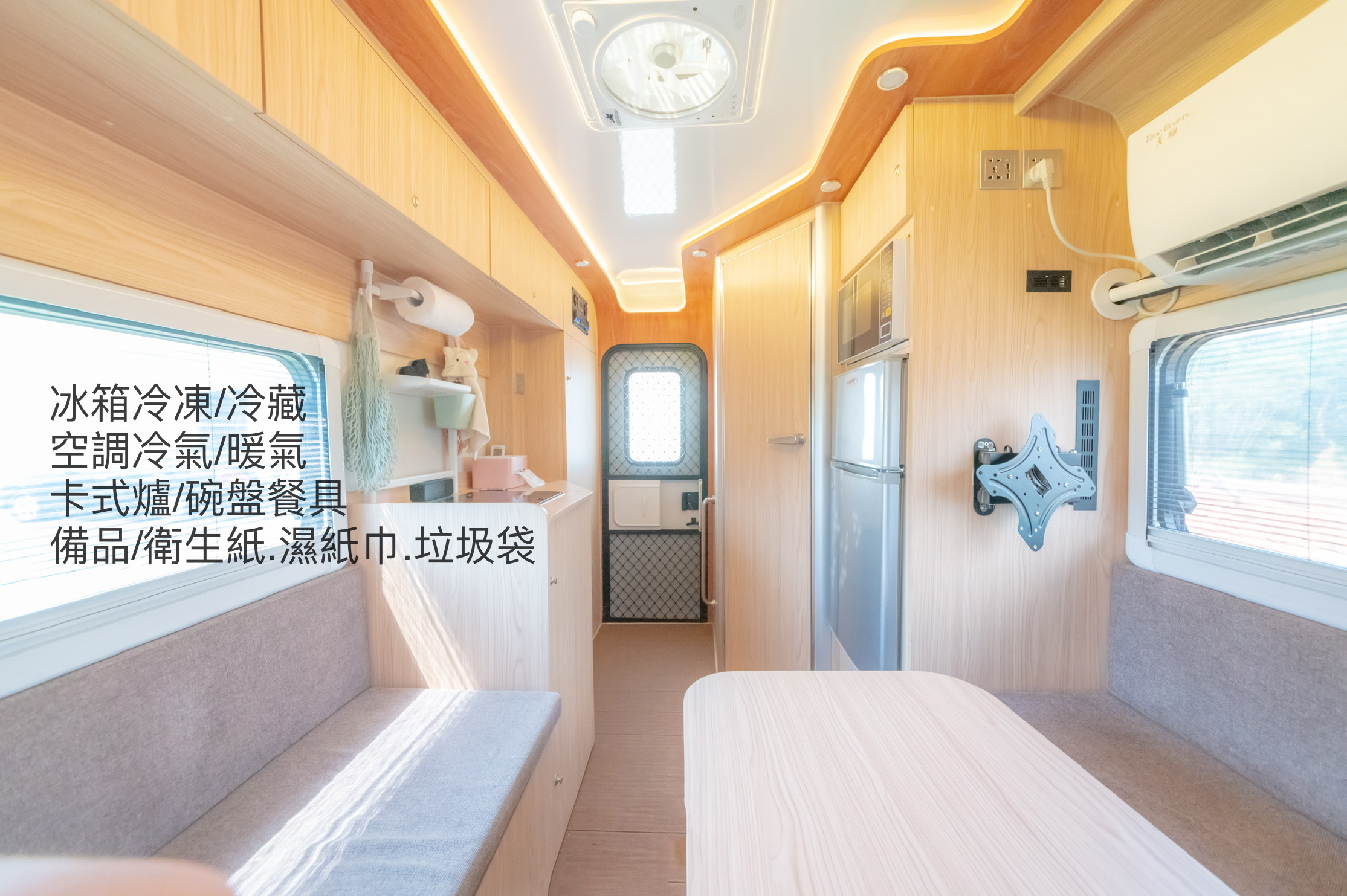 Taipei campervan interior mid-conversion: reconfiguring table and cushions to form the second double bed.