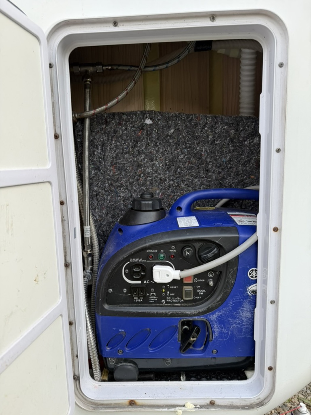 Taipei campervan: Yamaha blue built-in generator in the left rear compartment charges the campervan battery while driving or during the day.