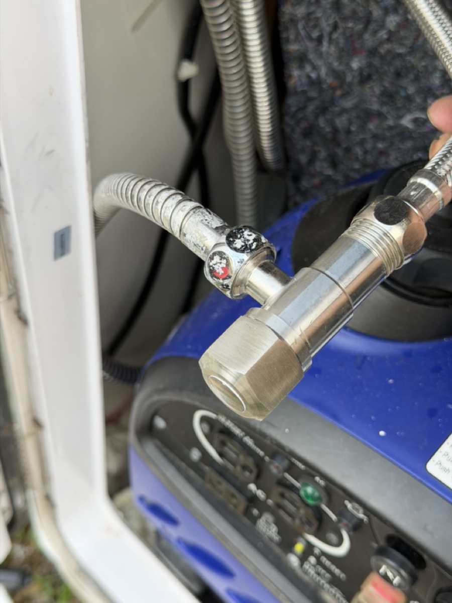 Taipei campervan rinse shower stainless hose and quick-connect close-up—check fitting before stowing after beach use.