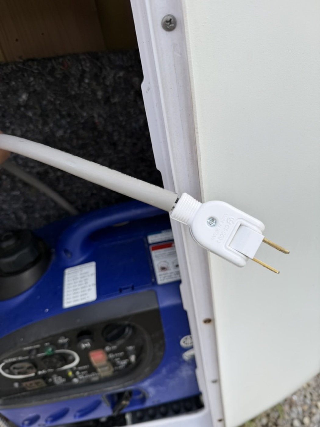Taipei campervan white two-pin charge plug in left rear bay—use extension cord to campsite outlet or generator AC socket.