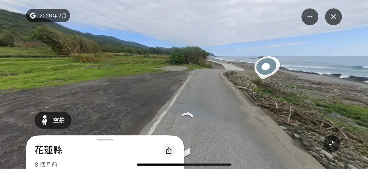 Google Street View showing a coastal side road, an open roadside area and an unobstructed view of the sea